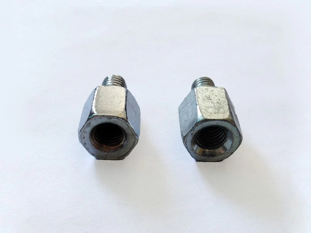 Two silver metal hexagonal bolts with threaded ends on a white background