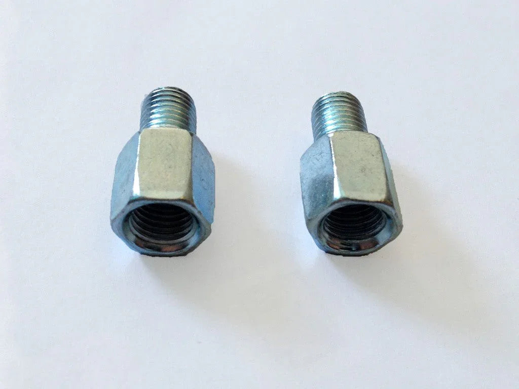 Two metal hexagonal threaded adapters on white background, metal pipe fitting connectors