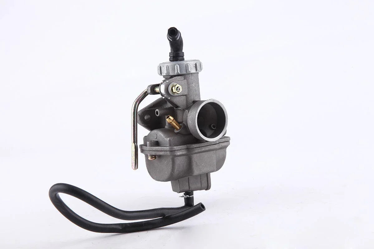 Metal carburetor with black fuel hose on white background for motorcycle engine