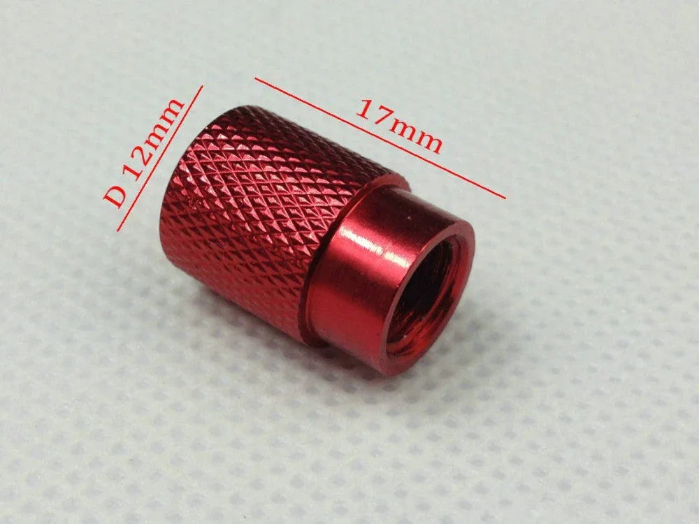 Red textured metal valve cap with 12mm diameter and 17mm length on white surface