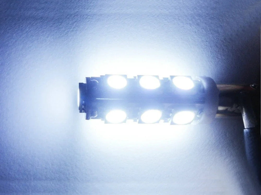 Bright white LED corn light bulb illuminated against a plain background with visible wiring