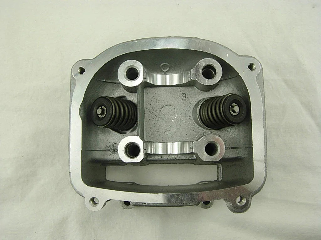 Metal engine cylinder head with two valve springs on a white background