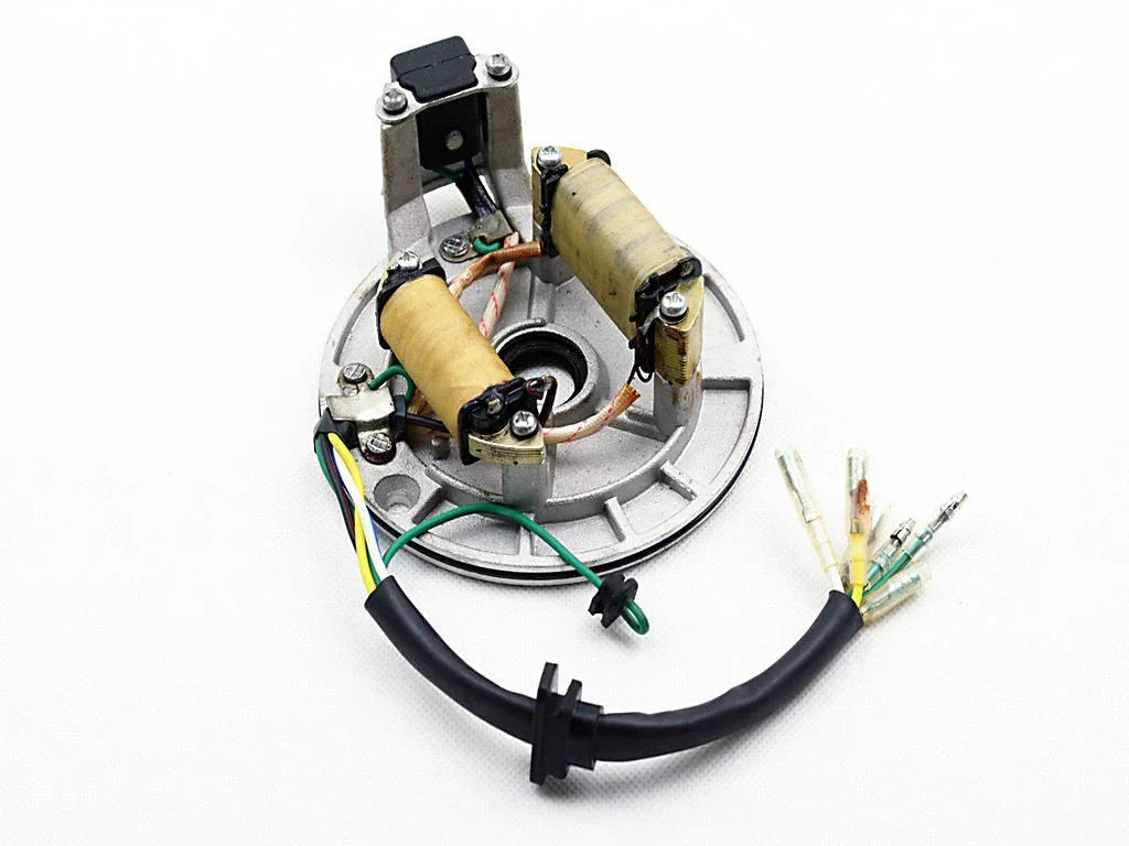 Motorcycle stator with coils and wiring harness on white background