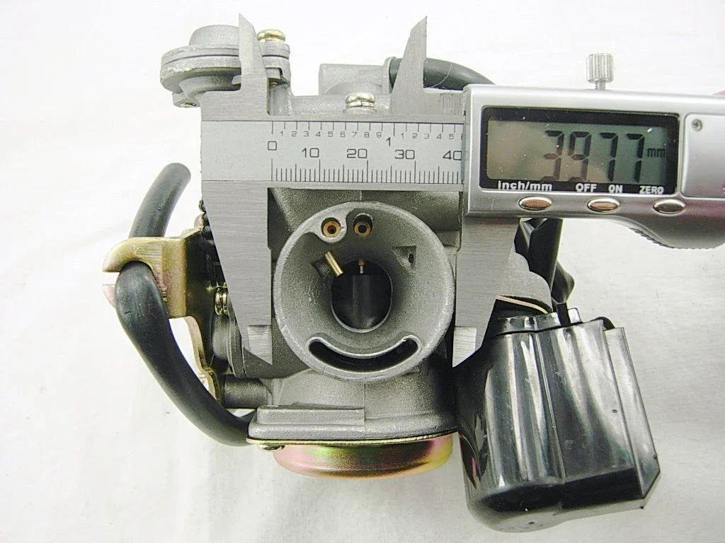 Close-up of a carburetor with digital caliper measuring 39.77 mm diameter on white background