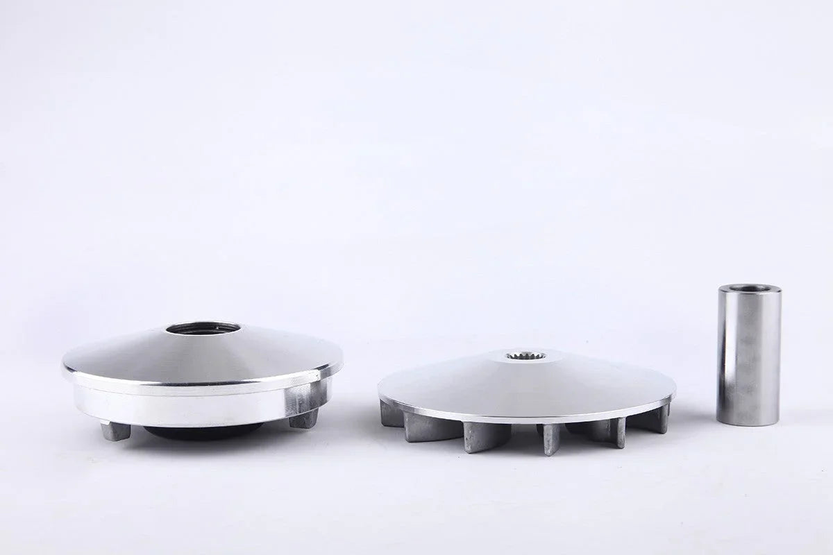 Two silver metal clutch bell housings and a cylindrical spacer on a white background