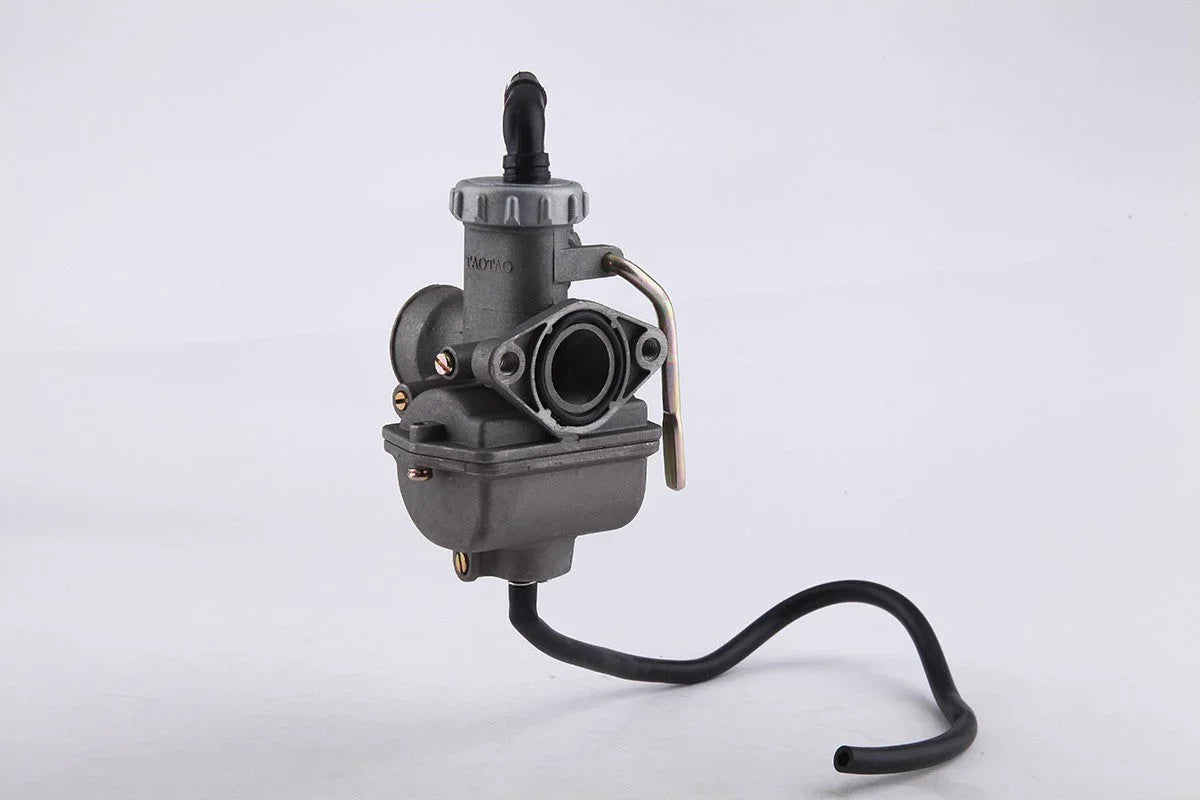 Gray carburetor engine part with black hose on white background