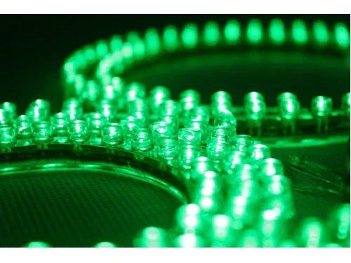 Close-up of green LED lights arranged in circular patterns on a dark surface