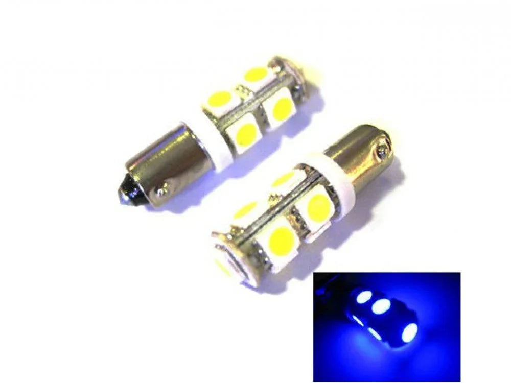 Pair of white LED car bulbs with yellow chips and inset showing blue light glow