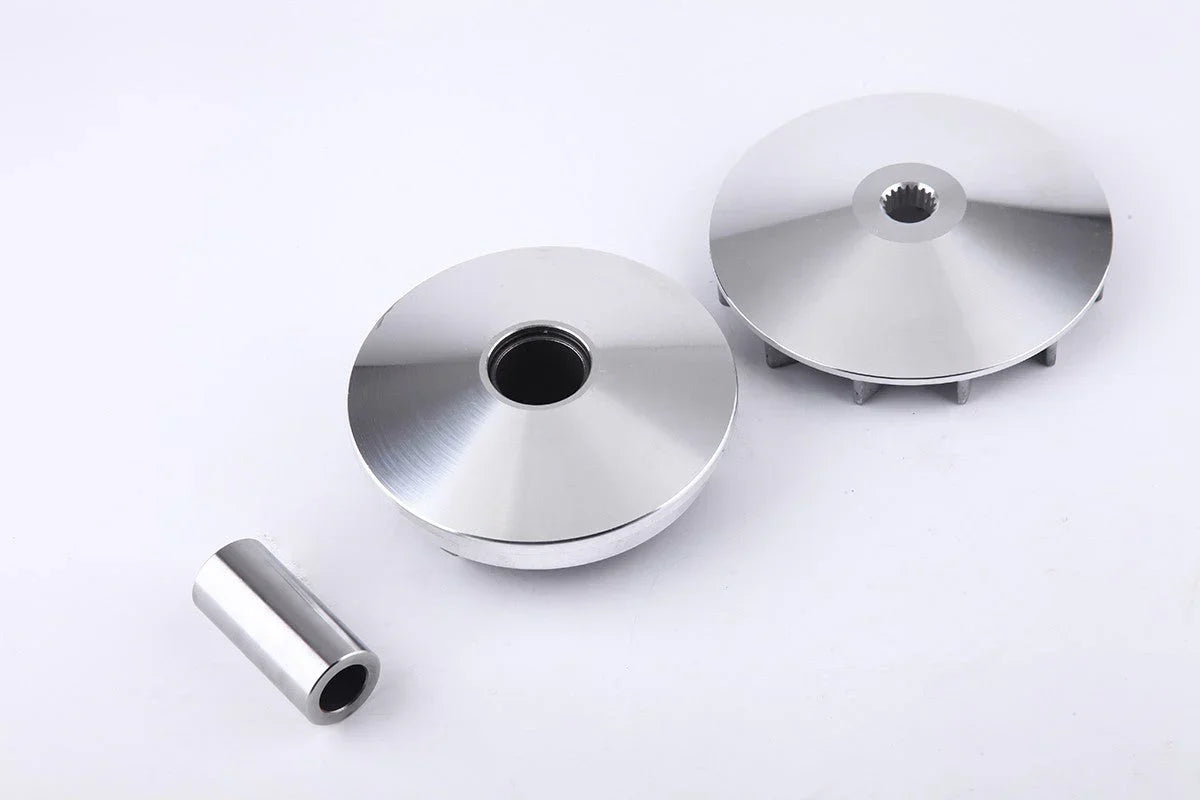 Three polished metal mechanical parts, including two round discs and a small cylindrical piece on white background