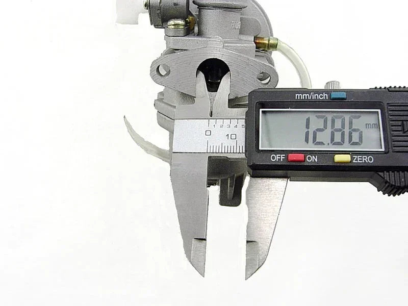 Digital caliper measuring carburetor throat diameter for motorcycle or ATV engine parts
