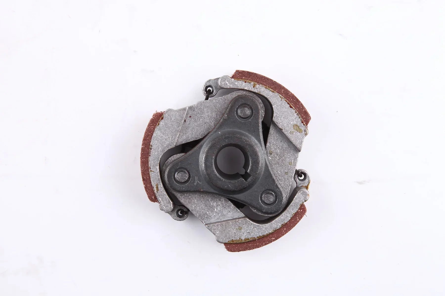 Clutch assembly for motorcycle or ATV engine with friction pads and metal housing