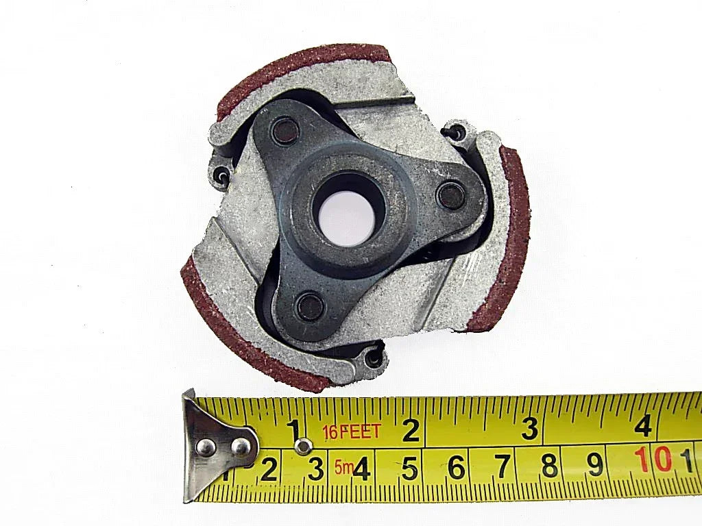 Clutch assembly for go-kart or ATV with red friction pads, shown with measuring tape for size reference