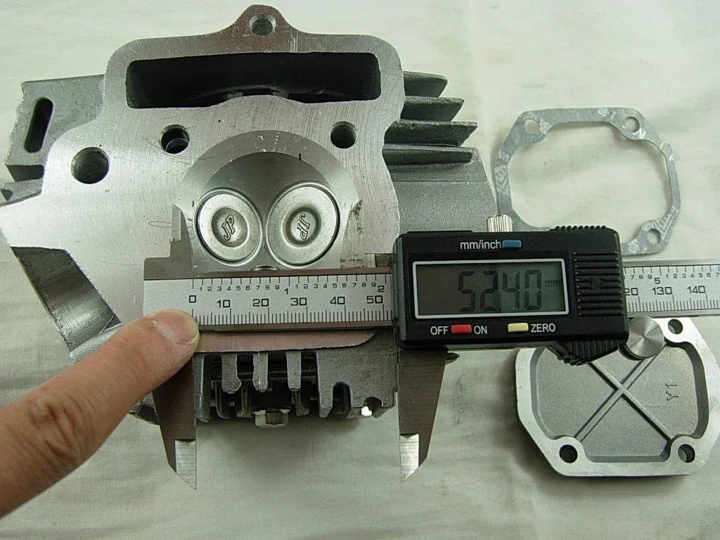 110cc engine cylinder head assembly for dirt bikes, made by ChinesePartsUSA, featuring metal components and mounting points.