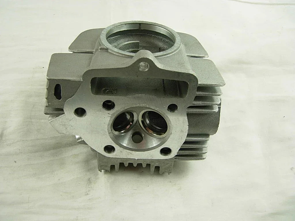 ChinesePartsUSA 125cc E22 style dirt bike engine cylinder head showing metal components and mounting points.