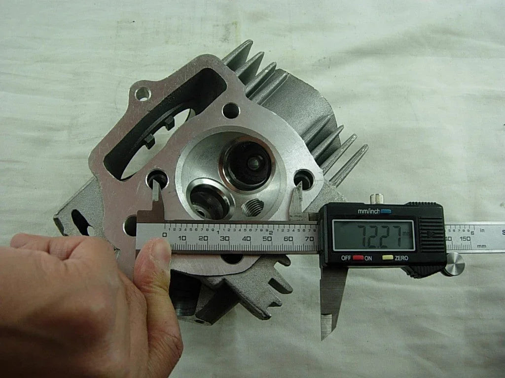 ChinesePartsUSA 125cc E22 style dirt bike engine cylinder head with cooling fins and metal components.