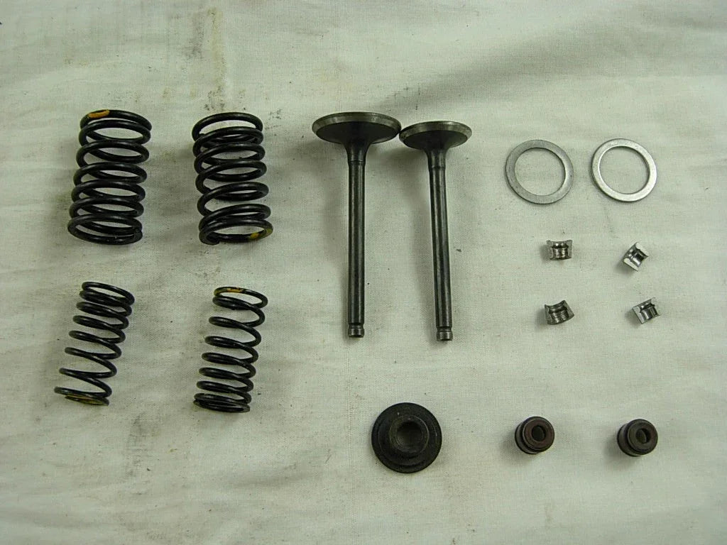 ChinesePartsUSA 125cc dirt bike valve assembly showing metal components and valve mechanism for engine performance.