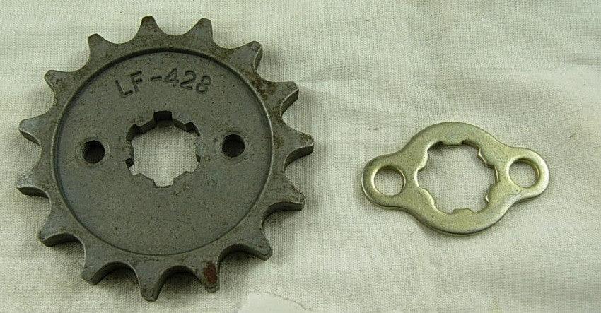 Metal LF-428 sprocket gear and a matching silver mounting plate on beige cloth