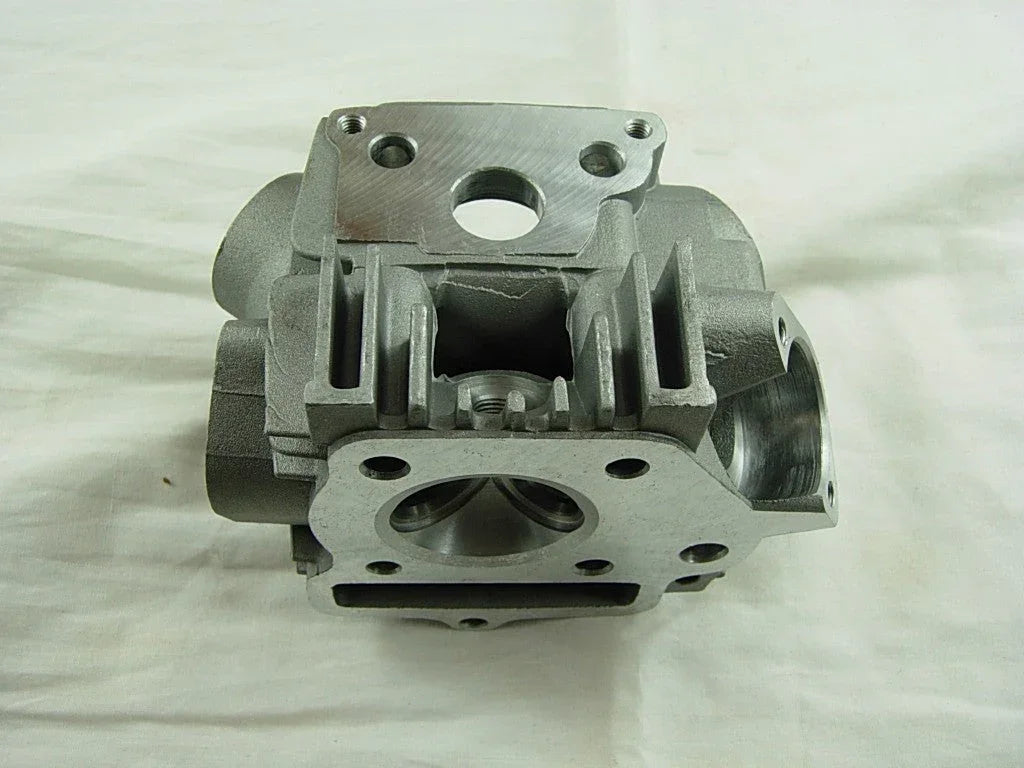 ChinesePartsUSA 70cc 90cc E22 style dirt bike engine cylinder head, metal with cooling fins, mounted on a dirt bike engine.