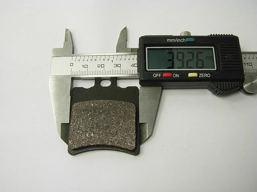 ChinesePartsUSA 125cc dirt bike brake pads set showing black rubber pads with metal backing plates for motorcycle braking.