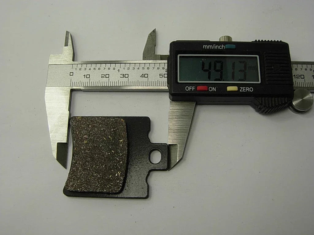 ChinesePartsUSA 125cc dirt bike brake pads set, durable replacement parts for off-road motorcycle braking system.