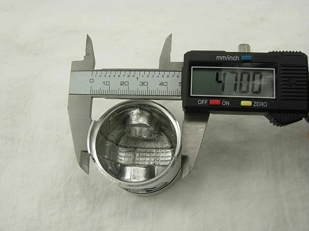 ChinesePartsUSA piston for 70cc and 90cc dirt bike engines, showing the metal piston component with cylinder grooves.