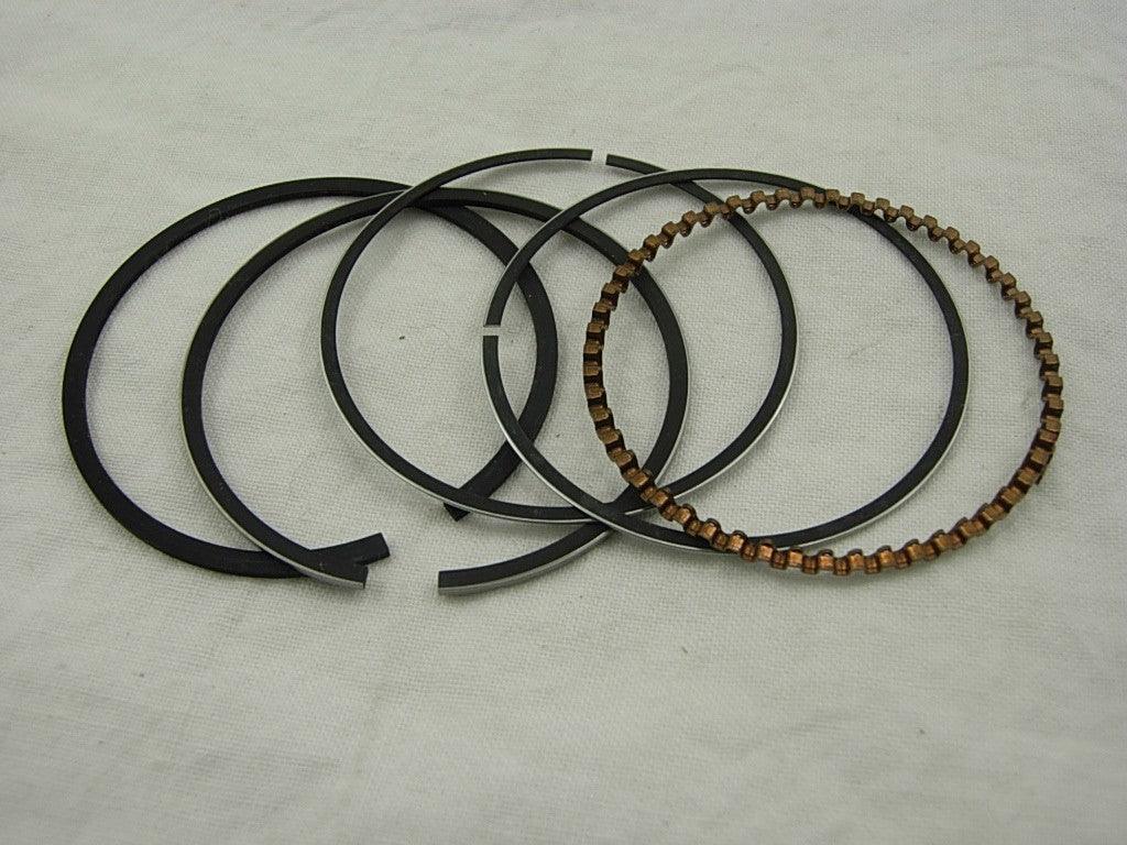Set of piston rings for 70cc and 90cc dirt bikes, ChinesePartsUSA brand, shown in a close-up view of the parts.