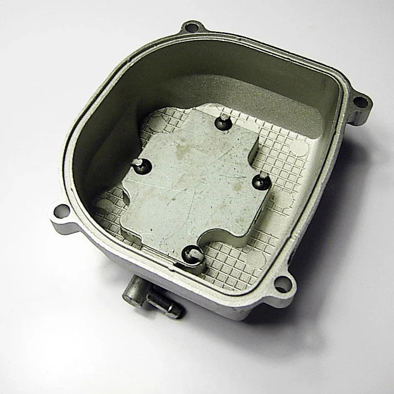 metal automotive carburetor float bowl component with mounting holes on white background