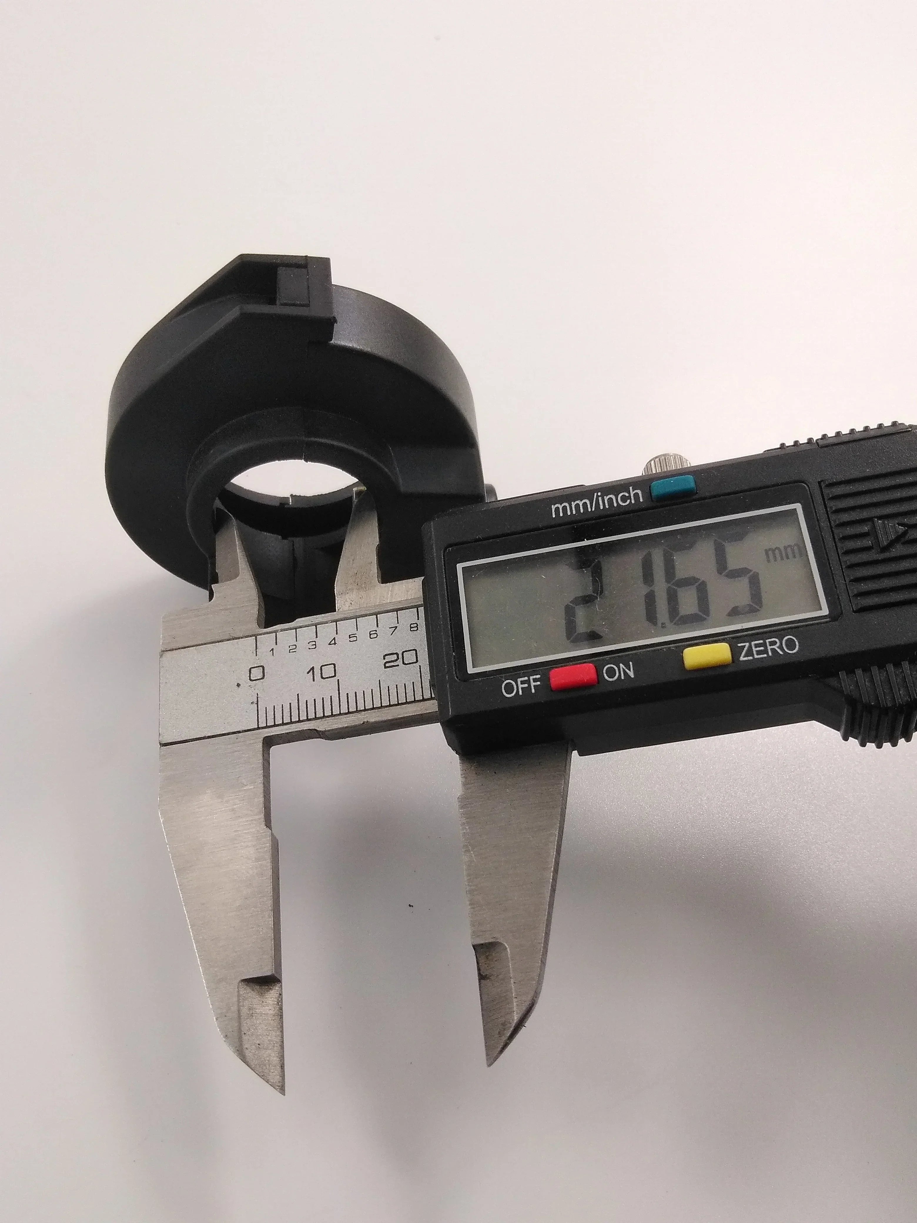 Black motorcycle or ATV part measured at 21.65mm with digital caliper for precision fit