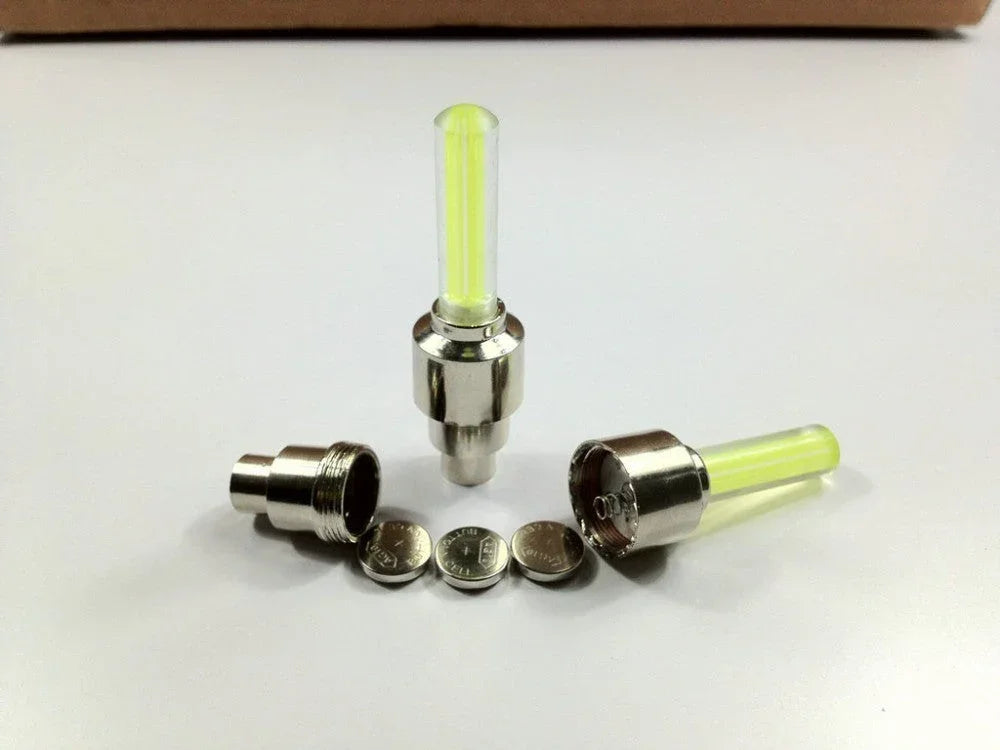 Two yellow LED car and bike bicycle tyre wheel valve lights, neon neon glow for vehicle accessories by ChinesePartsUSA.