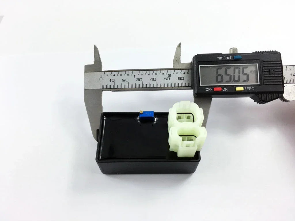 Digital caliper measuring small electrical connector for motorcycle or ATV parts, precise 65.05mm measurement