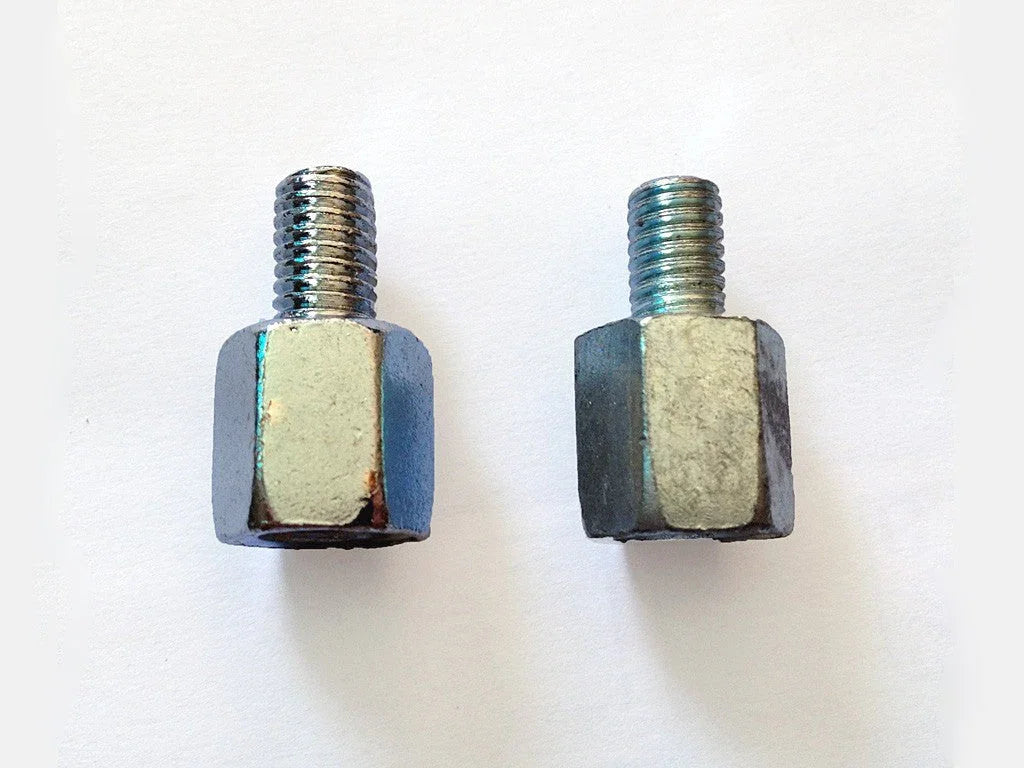 Two metal threaded hex standoffs on a white background, industrial hardware components
