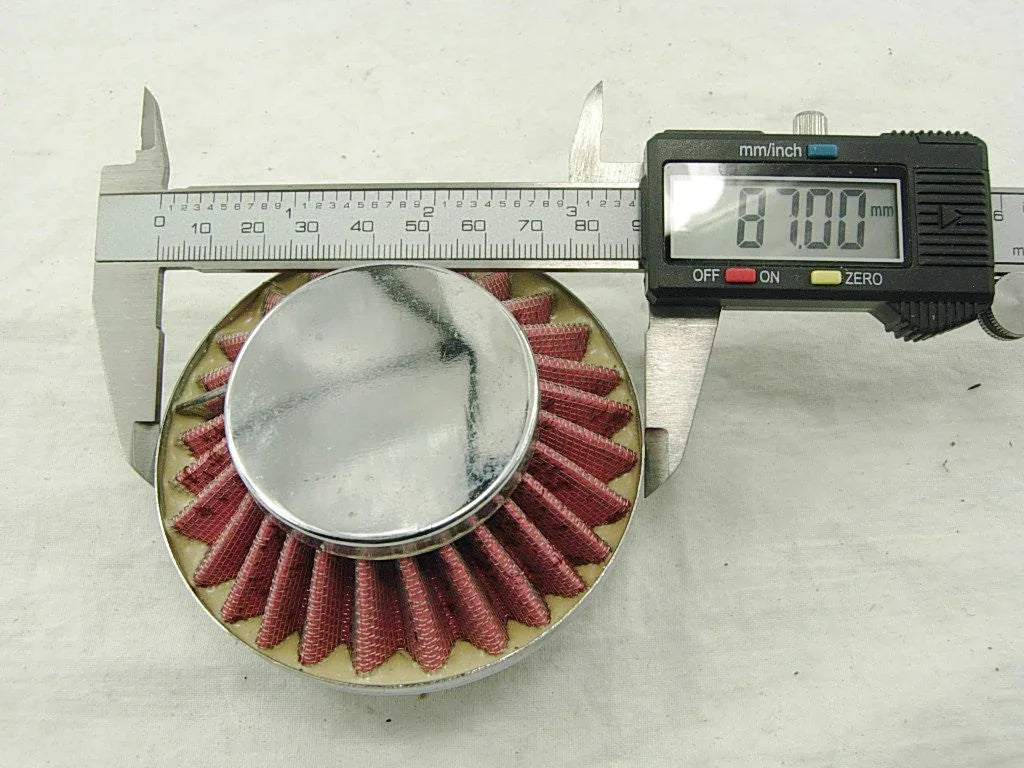 Digital caliper measuring diameter of round red pleated air filter showing 87 mm