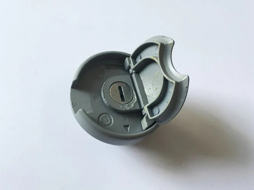 gray round lock cylinder with hinged cover on white background