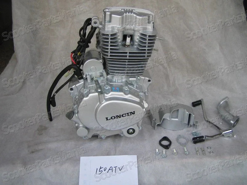 Silver Loncin 150cc ATV engine with wiring and mounting parts on grey fabric background