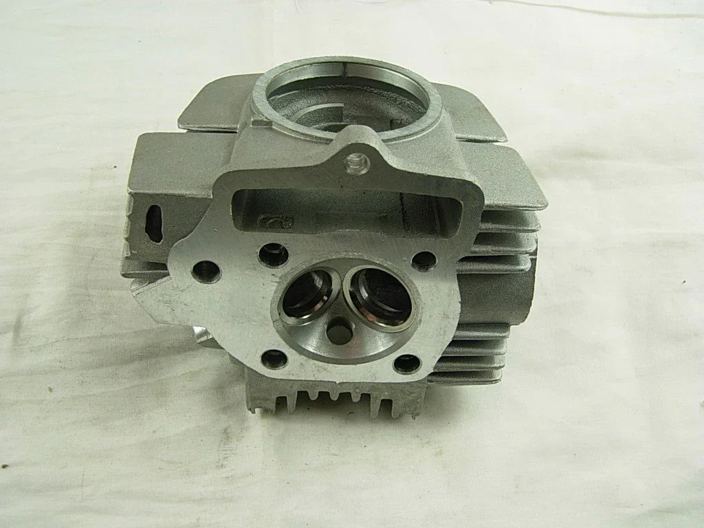 Horizontal style 110cc engine cylinder head for dirt bikes, durable metal construction, part of vendor-unknown dirt bike engine components