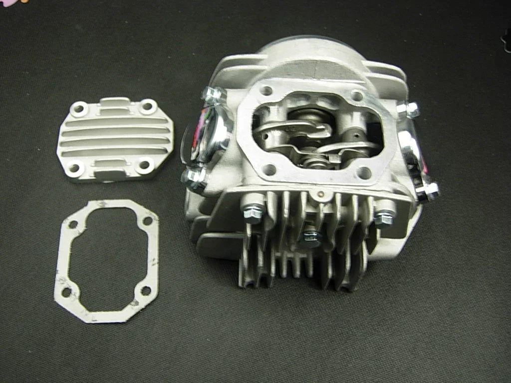 125cc E22 style dirt bike engine cylinder head assembly with cooling fins and valve openings, suitable for off-road motorcycle repair.