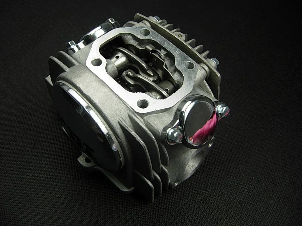 125cc E22 style dirt bike engine cylinder head assembly with metal components and mounting points for easy installation.
