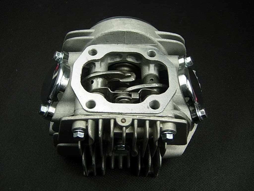 125cc E22 style dirt bike engine cylinder head assembly, black metal part with cooling fins and mounting points.