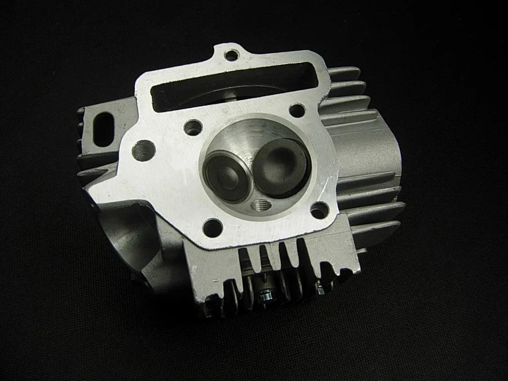 125cc E22 style engine cylinder head assembly for dirt bikes, durable metal construction, includes valve openings and mounting surfaces.