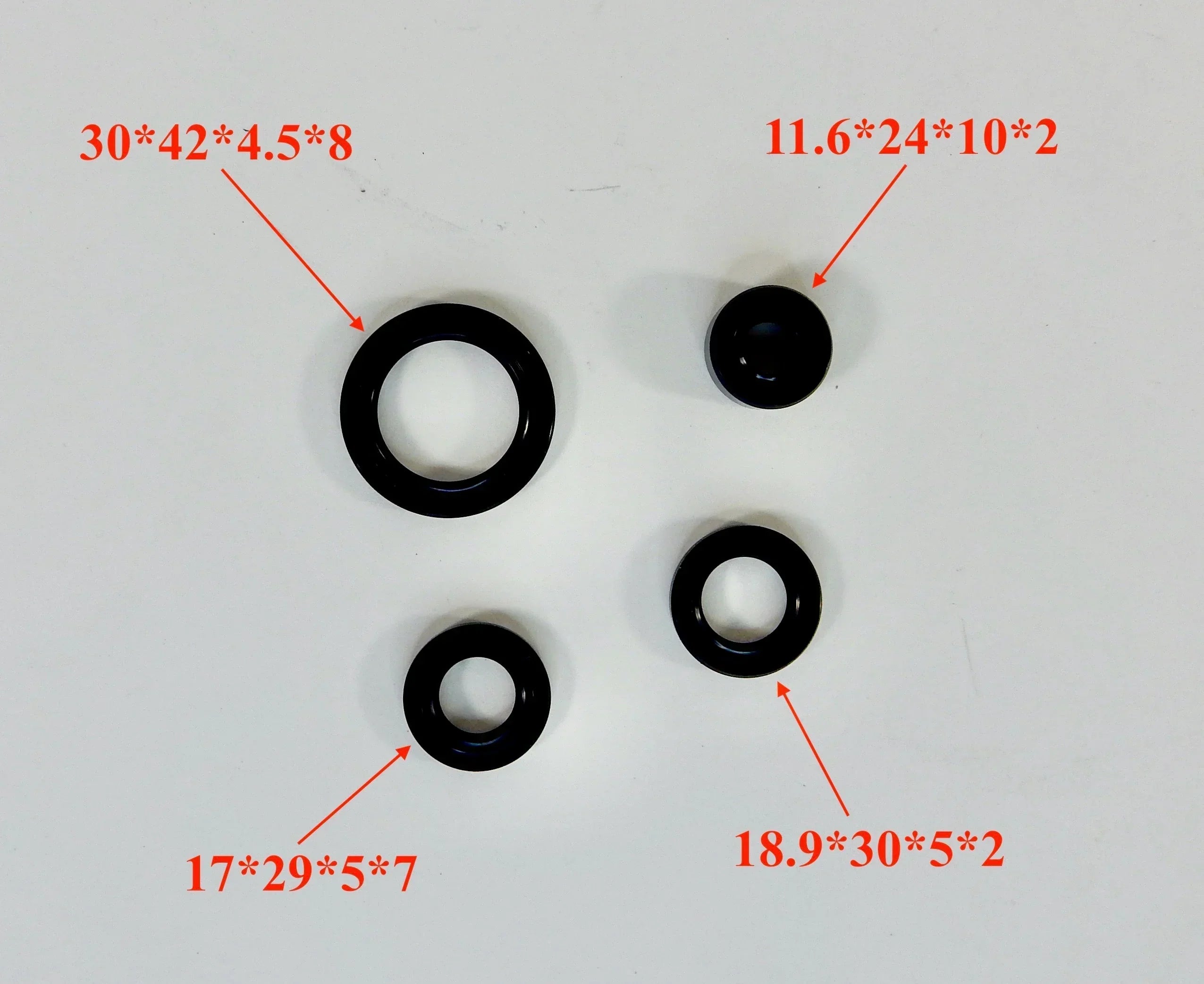Horizontal 125cc dirt bike engine gasket set with various gaskets and seals for engine repair and maintenance.