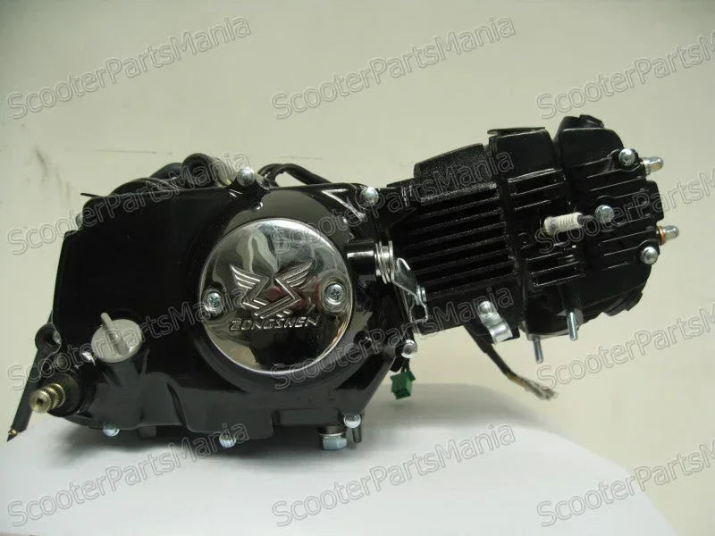 125cc Zongshen dirt bike engine for off-road motorcycle, shown with metal components and cooling fins, typical of dirt bike parts.