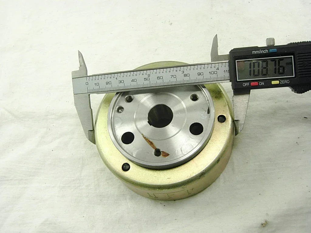 Dirt bike parts featuring a 2-coil magneto stator and rotor for 50cc, 110cc, and 125cc engines, compatible with various models