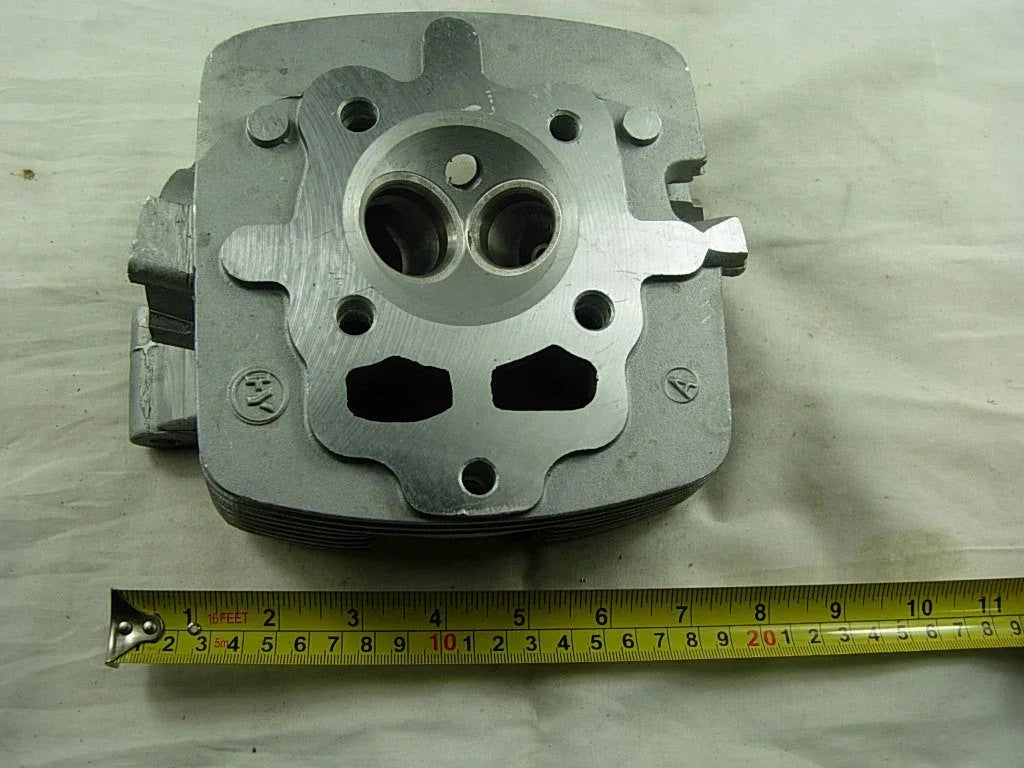 Cylinder head for CG200cc and 163ml 200cc dirt bike engines, shown in the image as a metal engine part.