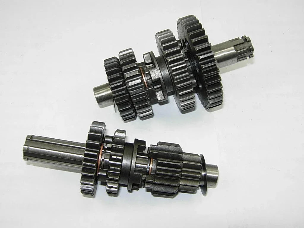 Dirt bike transmission main and counter shaft with gears for 50cc-125cc models, compatible with various dirt bike brands.