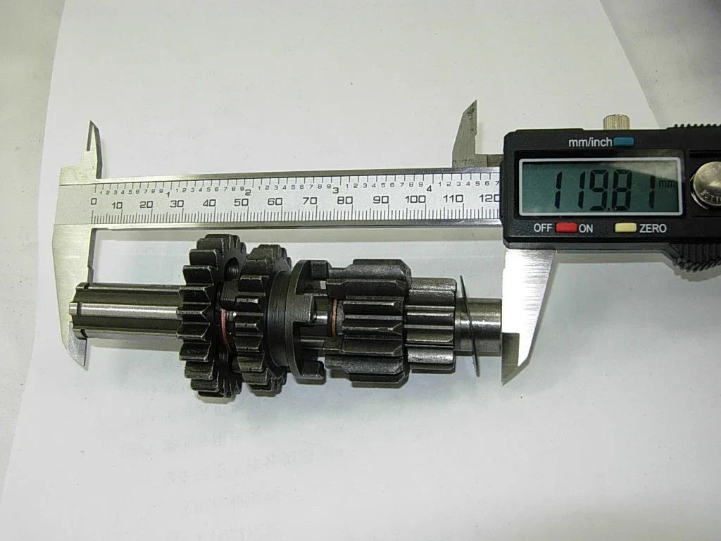 Dirt bike transmission main and counter shaft with gears for 50cc-125cc engines, compatible with various dirt bike models.