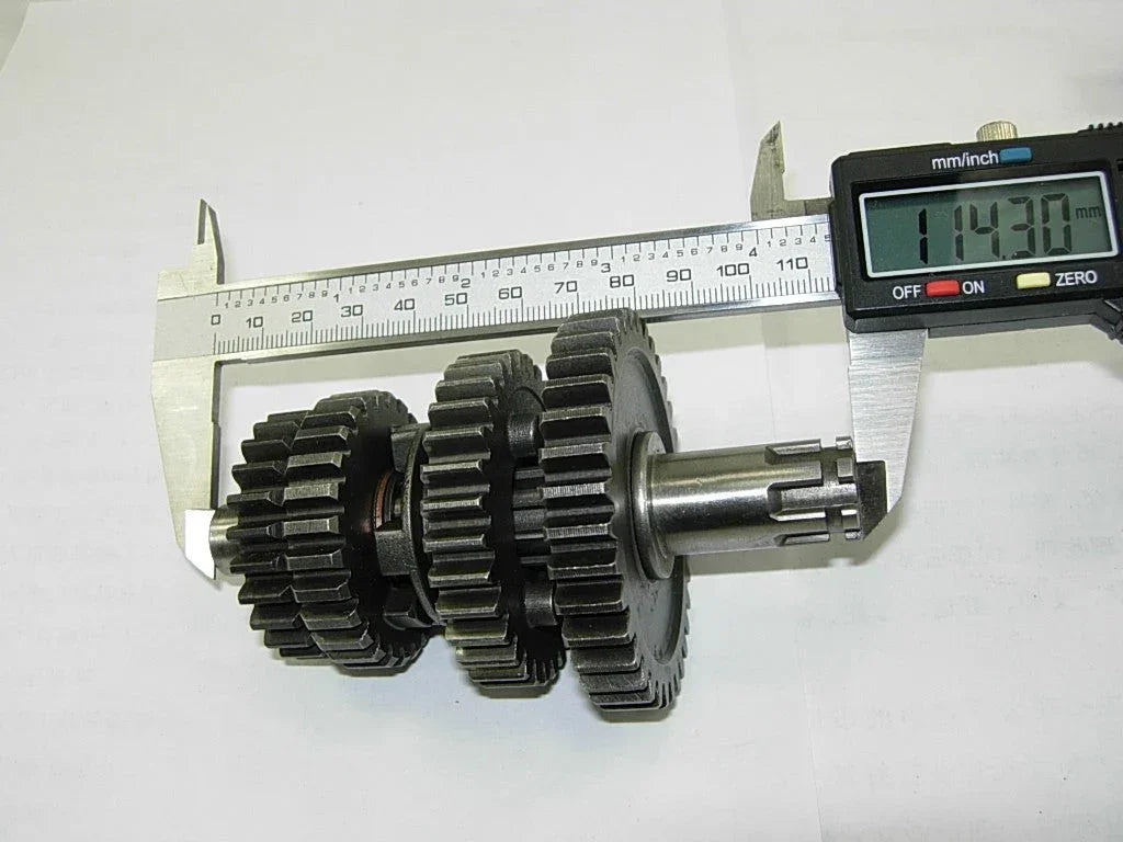 Dirt bike transmission main and counter shaft with gears for 50cc to 125cc models, compatible with various dirt bike brands.