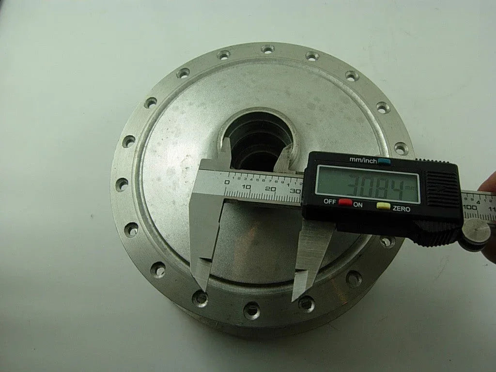 Front wheel hub for A100 engine motorcycle, showing the metal wheel component with mounting holes and spokes.