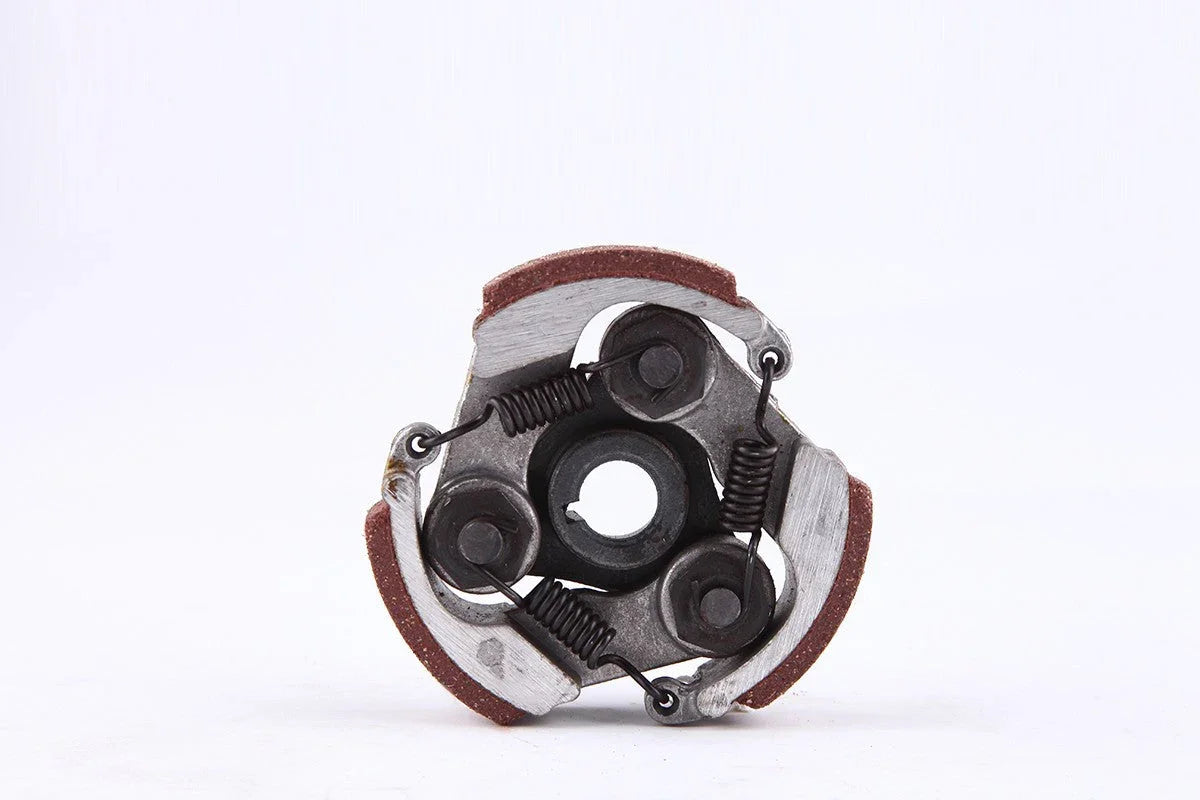 Close-up of a small mechanical clutch assembly with springs and friction pads on a white background