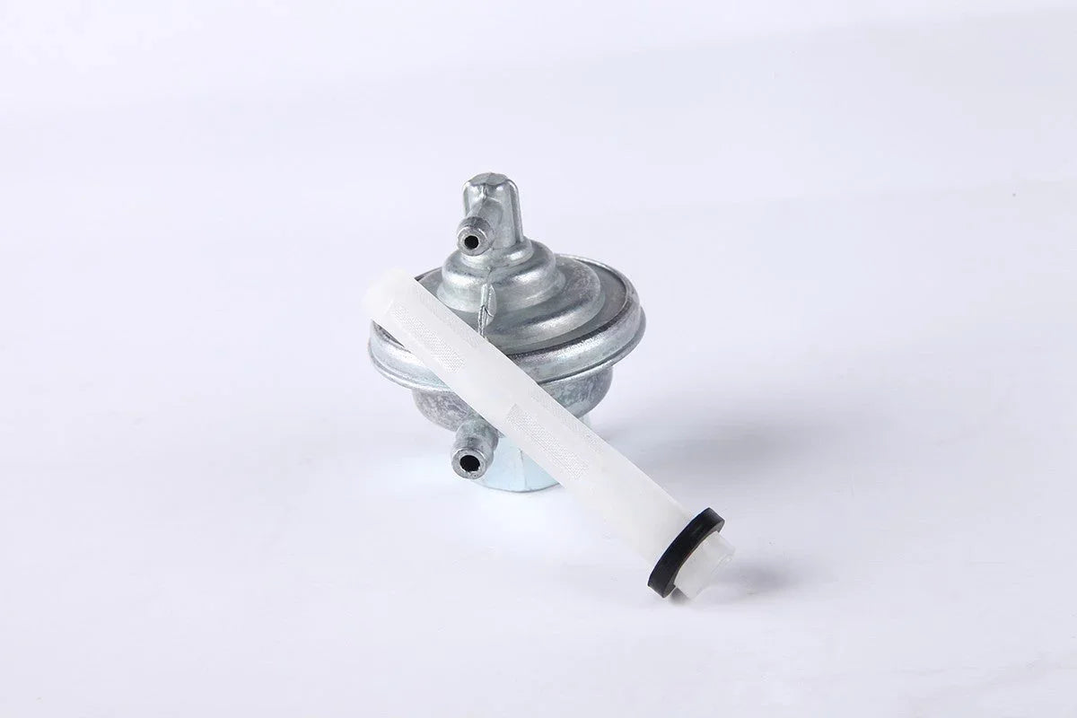 Metal fuel pump with attached white plastic filter on plain white background