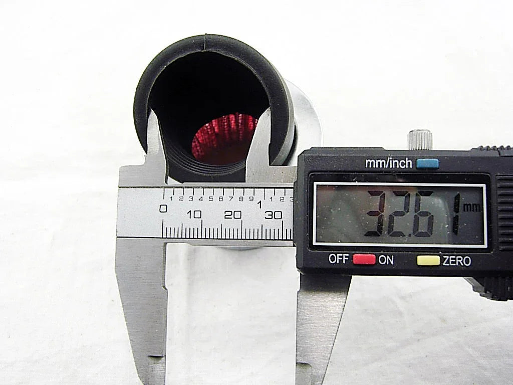 Digital caliper measuring diameter of a circular metal pipe showing 32.61 mm